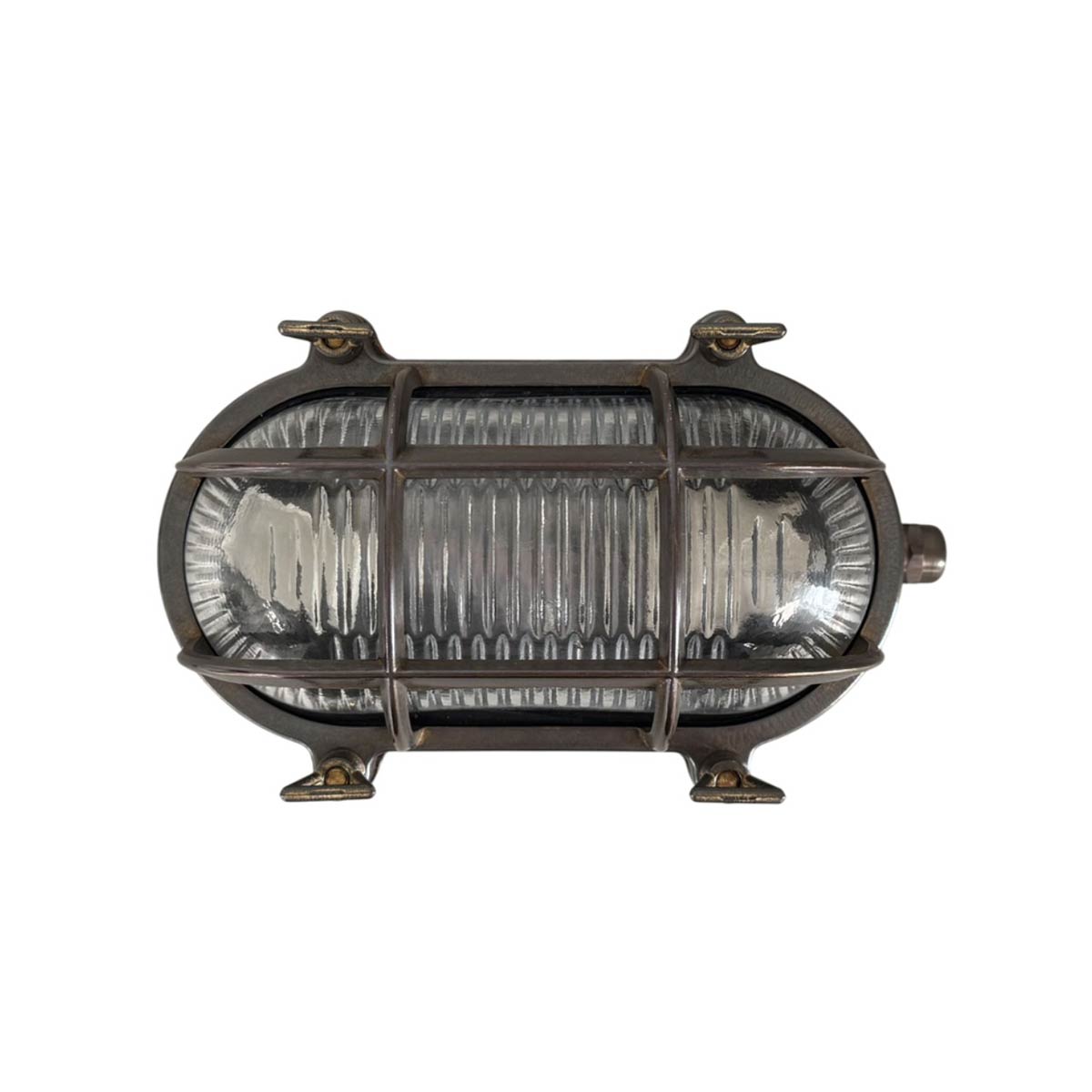 Small solid antique brass oval bulkhead light, rated IP64, shown horizontal on white background.