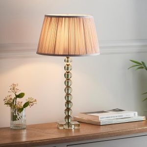 Adelie green crystal table lamp with dusky pink silk shade on lounge sideboard