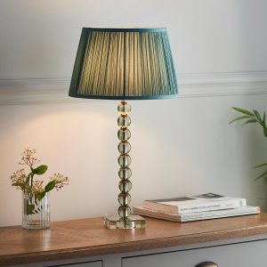 Adelie green crystal table lamp with fir silk shade on sitting room sideboard