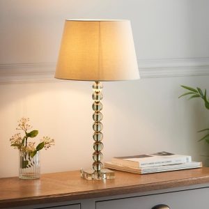 Adelie stacked green crystal table lamp with ivory linen mix shade on sitting room sideboard
