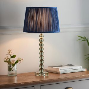 Adelie stacked green crystal table lamp with blue silk shade on sitting room sideboard