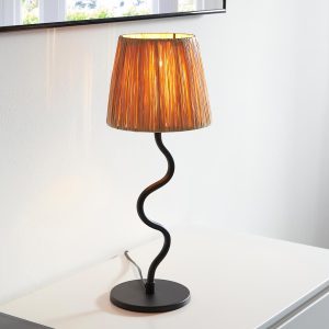 Wriggle table lamp in matt black with raffia shade on sideboard