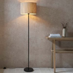 Longshaw single light floor lamp with natural seagrass shade, next to table in sitting room