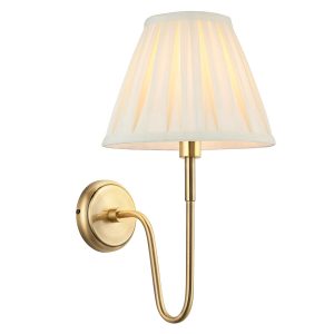 Rouen antique brass wall light with cream pleated shade on white background lit