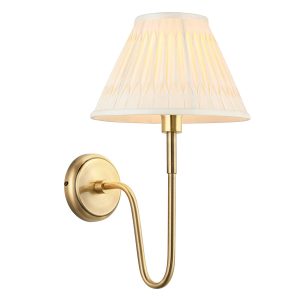 Rouen antique brass wall light with ivory silk shade on white background lit