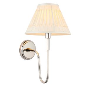 Rouen polished nickel wall light with ivory silk shade on white background lit