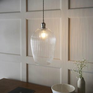 Timeless large ribbed glass kitchen pendant in polished nickel, shown over a dining room sideboard.
