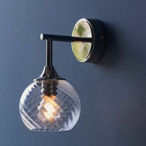 Allegra polished nickel wall light with twisted glass shade on dark blue wall