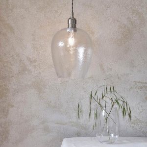 Small hammered glass kitchen pendant in polished nickel, shown over a sideboard.