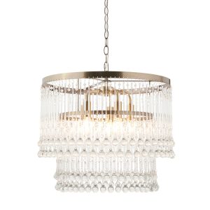 Genevieve 5 light pendant in an antique brass finish with clear glass drops on white background, lit.