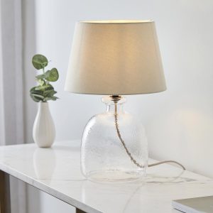 Lyra textured glass table lamp with ivory shade on dining room sideboard