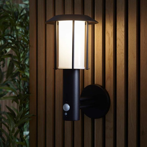 Tarrow modern solar outdoor wall light in black on garden fence