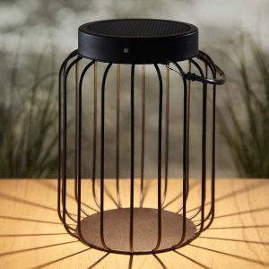 Tropic Solar Powered outdoor table lantern in black on table in garden at night