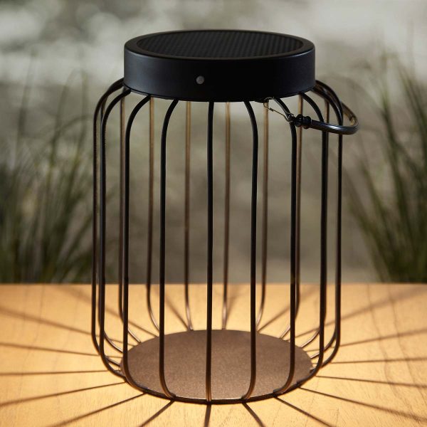 Tropic Solar Powered outdoor table lantern in black on table in garden at night