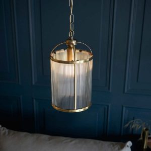 Lambeth 1 light pendant lantern in antique brass with ribbed glass hanging in grey panelled room