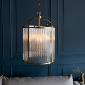 Lambeth 4 light pendant lantern in antique brass with ribbed glass in grey panelled room