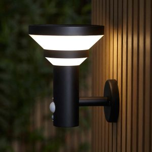 Halton modern solar outdoor light in black with PIR side view on garden fence