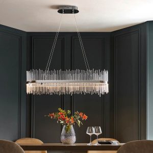 Polished chrome dimmable LED linear pendant with twisted glass rods, shown above a dining room table.