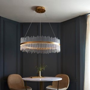 Large matt gold LED hoop pendant with twisted glass rods, shown over circular dining room table.