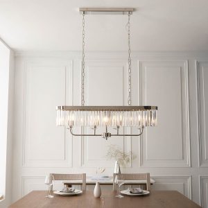 Linear 4 light pendant in polished nickel with cut glass drops, shown over a dining room table.
