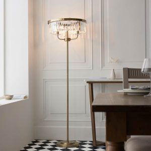 Antique brass floor lamp with 3 lights and cut glass drops, shown in a dining room setting.