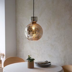 High quality kitchen pendant with mercury bubble glass shade and brass plated metalwork, shown over a dining room table.