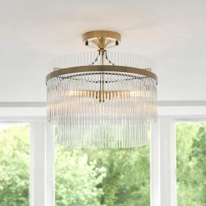 Marietta 3 light semi flush ceiling light in antique brass with clear glass rods, shown on room ceiling.