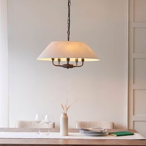 Lille classic 5 light pendant in matt black with natural faux linen shade, over a dining room table.