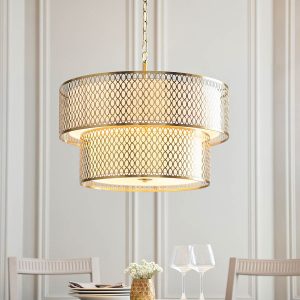 Cordero 6 light 2 tier ceiling pendant in gold finish, shown over a dining room table.