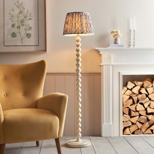 Higgledy floor lamp standard in almond white with pearl grey Ikat shade, shown lit in lounge.