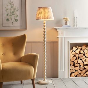 Higgledy floor lamp standard in almond white with neutral Ikat shade, shown lit in lounge.