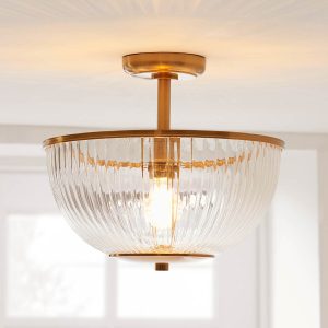 Somerset semi flush uplighter in vintage brass with ribbed glass shade, shown fitted to room ceiling.