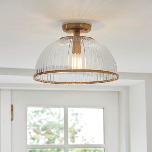 Somerset flush ribbed glass downlighter in vintage brass, shown on room ceiling.