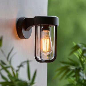 Lucca nautical inspired outdoor wall lantern in matt black and rated IP44, shown on exterior wall corner.