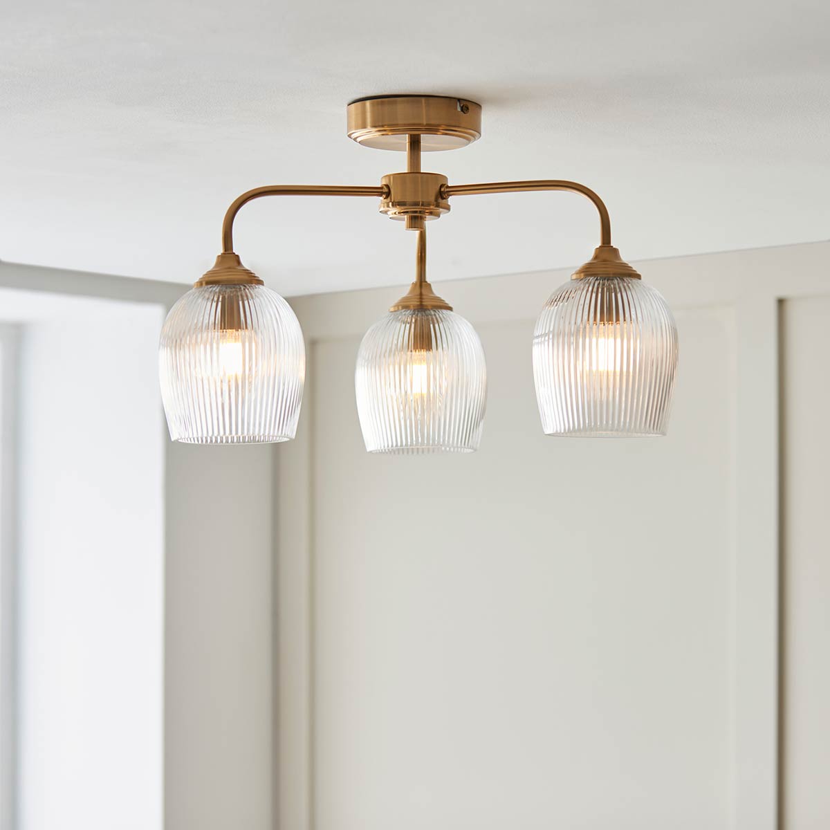 Ashcroft 3 Light Semi Flush in Aged Brass with Ribbed Glass