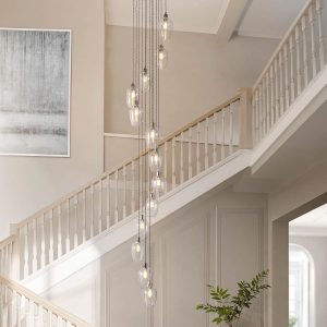 13 light stairwell pendant in polished nickel with clear glass goblet shades, shown in large hallway.