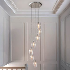 7 light stairwell pendant in polished nickel with clear glass goblet shades, shown on hall landing.