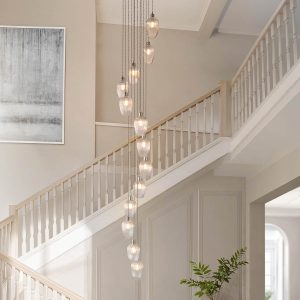 13 light stairwell pendant in polished nickel with ribbed glass goblet shades, shown in large hallway.