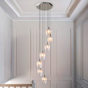 7 light stairwell pendant in polished nickel with ribbed glass goblet shades, shown on hall landing.