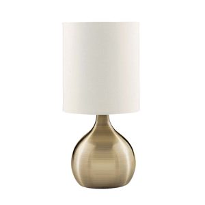 Touch table lamp with antique brass vase base and white shade on white background