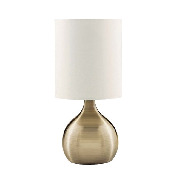 Touch table lamp with antique brass vase base and white shade on white background