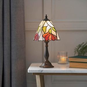 Botanica mini Tiffany table lamp with floral design, shown on living room side table.