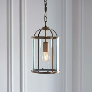 Lambeth 1 light pendant lantern in antique brass hanging in white panelled room