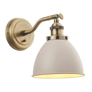Franklin switched wall light in antique brass with taupe shade on white background