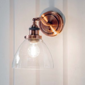 Hansen switched industrial wall light in aged copper on room wall