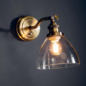 Hansen switched industrial wall light in antique brass on wall