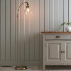 Hansen 1 light floor lamp in antique brass next to sideboard in sitting room