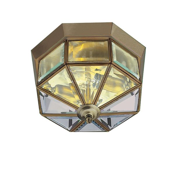 Traditional hexagonal antique brass 2 lamp flush ceiling light with clear bevelled edge glass on white background.