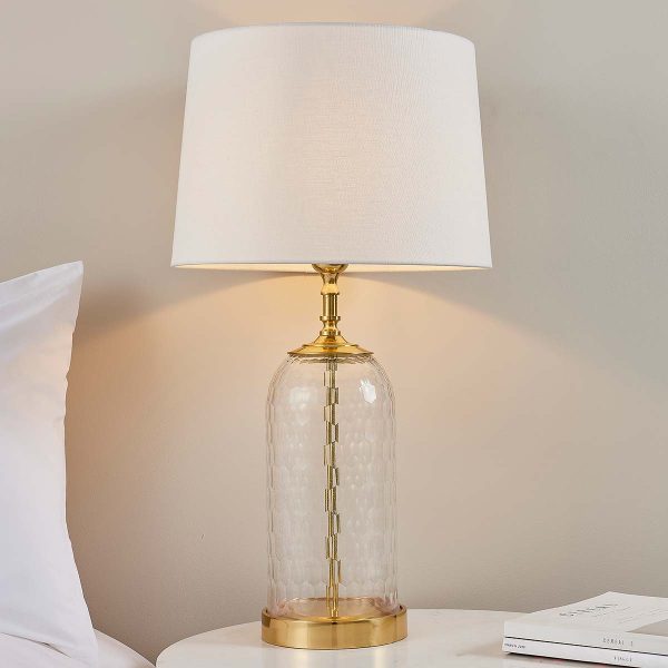 Wistow 1 light cut glass table lamp in solid brass with white linen shade on bedside table