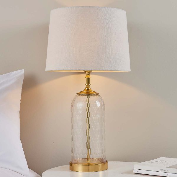 Wistow 1 light cut glass table lamp in solid brass with natural linen shade on bedside table